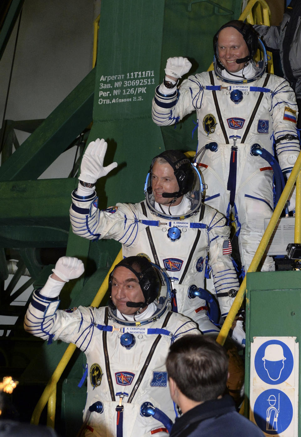 U.S. astronaut Steven Swanson, center, Russian cosmonauts Alexander Skvortsov, bottom, and Oleg Artemyev, crew members of the mission to the International Space Station (ISS) gesture prior the launch of Soyuz-FG rocket at the Russian leased Baikonur cosmodrome, Kazakhstan, Wednesday, March 26, 2014. (AP Photo/Vasily Maximov, Pool)