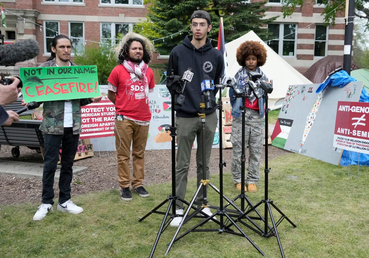 Ameen Atta, center, a board member with the Muslim Student Association, speaks to the media next to Audari Tamayo, left, and Kayla Patterson, right, both members of UWM Students for a Democratic Society, at an encampment outside Mitchell Hall on the University of Wisconsin-Milwaukee campus, protesting the Israel-Hamas war, in Milwaukee on Monday. UWM and pro-Palestinian protesters reached an agreement Sunday afternoon, two weeks after tents went up on the lawn outside Mitchell Hall, in defiance of a state rule banning camping on campus property.