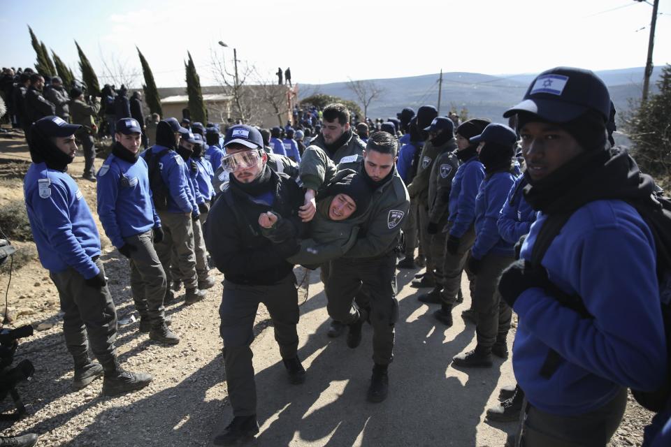 Israeli police evicts settlers from the West Bank outpost of Amona, Thursday, Feb. 2, 2017. Israeli police removed the remaining Israeli protesters from the West Bank outpost of Amona, which forces are evacuating under court order. The evacuation began Wednesday. Amona is the largest of about 100 unauthorized outposts erected in the West Bank without formal permission but with tacit Israeli government support. The outpost was found to be built on private Palestinian land and the Israeli Supreme Court ordered it demolished. (AP Photo/Oded Balilty)