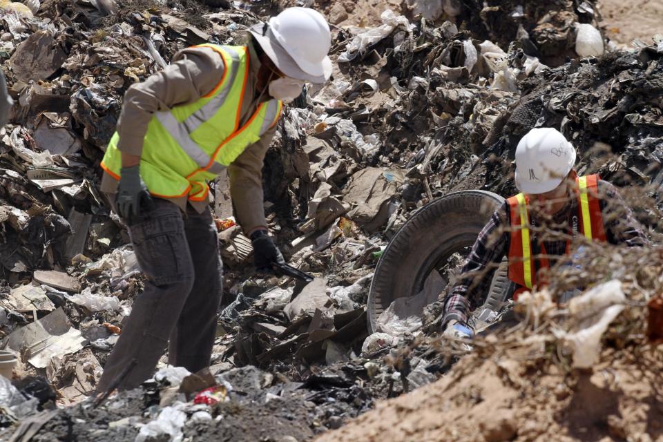 Workers sift through trash in search for decades-old Atari 'E.T. the Extra-Terrestrial' game cartridges in Alamogordo, N.M., Saturday, April 26, 2014. Producers of a documentary dug in an southeastern New Mexico landfill in search of millions of cartridges of the game that has been called the worst game in the history of video gaming and were buried there in 1983. (AP Photo/Juan Carlos Llorca)