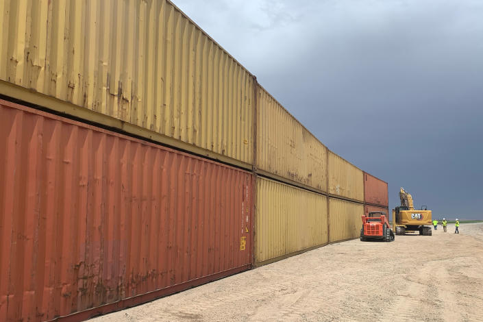 FILE - This photo provided by the Arizona Governor's Office shows shipping containers that will be used to fill a 1,000 foot gap in the border wall with Mexico near Yuma, Ariz., on Aug. 12, 2022. The Cocopah Indian Tribe said Friday, Sept. 2, that the state of Arizona acted against its wishes by stacking shipping containers on its land to prevent illegal border crossings. (Arizona Governor's Office via AP, File)