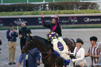 Jockey Junior Alvarado throws flower petals into the air after Art Collector won the Pegasus World Cup Invitational horse race Saturday, Jan. 28, 2023, at Gulfstream Park in Hallandale Beach, Fla. (AP Photo/Lynne Sladky)