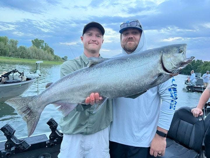 Jared Frye and David Guerra heft up a 30-pound king salmon caught in the Barge Hole on the Sacramento River with guide Jacob Frye on Aug. 1.