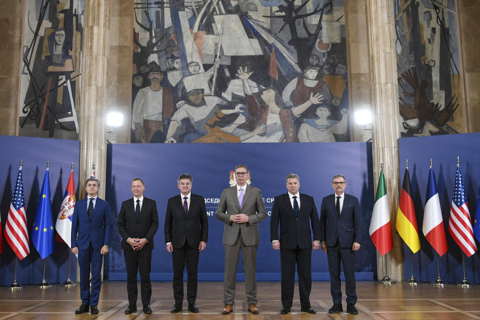 In this photo provided by the Serbian Presidential Press Service, Serbian President Aleksandar Vucic, third right, poses with Italian diplomat Alessandro Cattaneo, left, French President's Advisor Emmanuel Bonne, second left, European Union envoy Miroslav Lajcak, third left, US Deputy Assistant Secretary Gabriel Escobar , second right, and German Chancellor's Advisor Jens Plettner, right, in Belgrade, Serbia, Saturday, Oct. 21, 2023. The envoys of the European Union and the United States urged on Saturday Kosovo and Serbia to resume dialogue as the only way to de-escalate the soaring tension between the two nations. This is the first such visit since Sept. 24 when around 30 Serb gunmen crossed into northern Kosovo, killing a police officer and setting up barricades, before launching an hours-long gun battle with Kosovo police. (Serbian Presidential Press Service via AP)