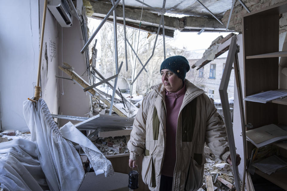 Valentyna Mozgova, 55, lab medic stands inside a hospital which was damaged by Russian shelling in Krasnohorivka, Ukraine, Sunday, Feb. 19, 2023. (AP Photo/Evgeniy Maloletka)