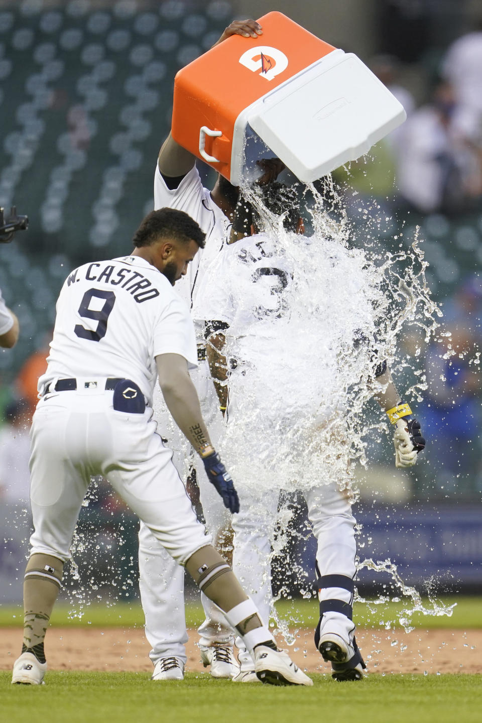 Detroit Tigers' Harold Castro is doused with water by Niko Goodrum after his game winning single against the Chicago Cubs in the 10th inning of a baseball game in Detroit, Saturday, May 15, 2021. Detroit won 9-8. (AP Photo/Paul Sancya)