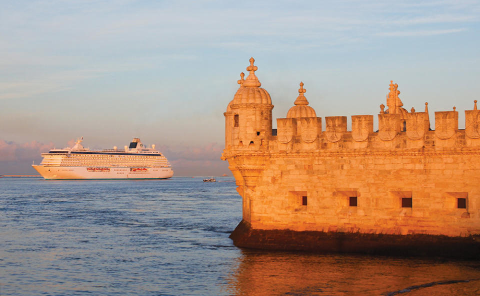 A cruise ship outside a castle. 