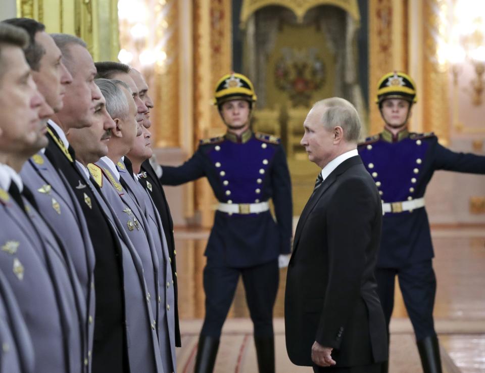 Russian President Vladimir Putin greets senior military officers during a meeting in Moscow, Russia, Wednesday, Nov. 6, 2019. Putin said Russia's new weapons have no foreign equivalents but he insists the country will not use them to threaten anyone. (Mikhail Klimentyev, Sputnik, Kremlin Pool Photo via AP)