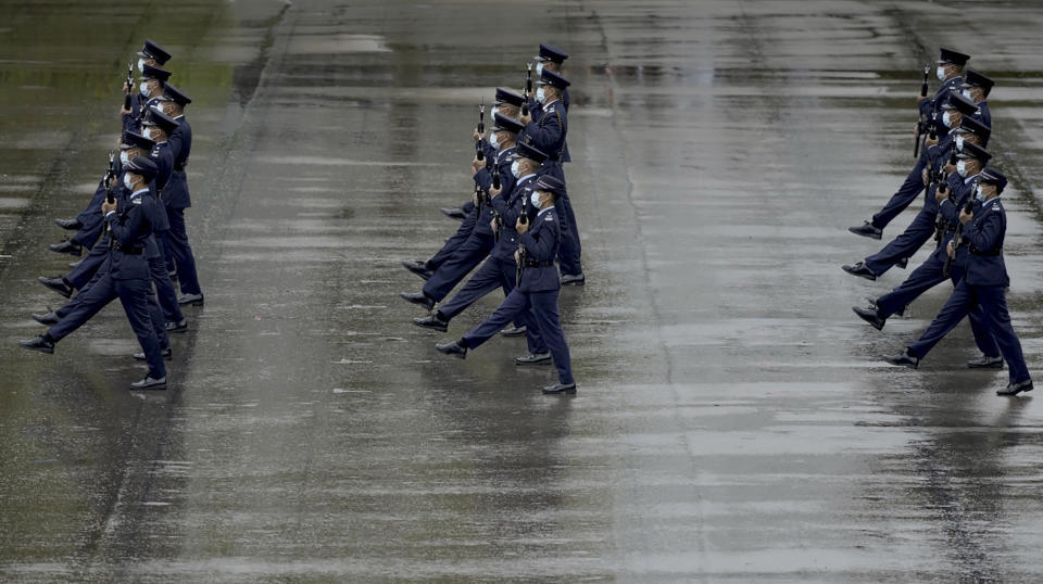 Hong Kong police show their new goose step marching style on the National Security Education Day at a police school in Hong Kong Thursday, April 15, 2021. Authorities in Hong Kong are marking the day with a police college open house, where police personnel demonstrated the Chinese military's "goose step" march, replacing British-style foot drills. The "goose step" march is one in which troops swing their legs off the ground in unison, keeping each leg straight. (AP Photo/Vincent Yu)