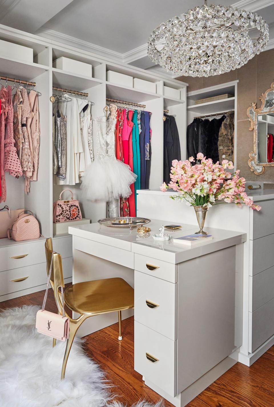 The dressing room was designed in collaboration with California Closets. Chandelier by Aerin from Circa lighting; chair by CB2.