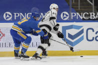 St. Louis Blues' Tyler Bozak (21) battles Los Angeles Kings' Mikey Anderson (44) for the puck during the second period of an NHL hockey game Saturday, Jan. 23, 2021, in St. Louis. (AP Photo/Joe Puetz)