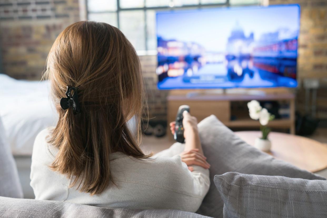 woman watching tv at home