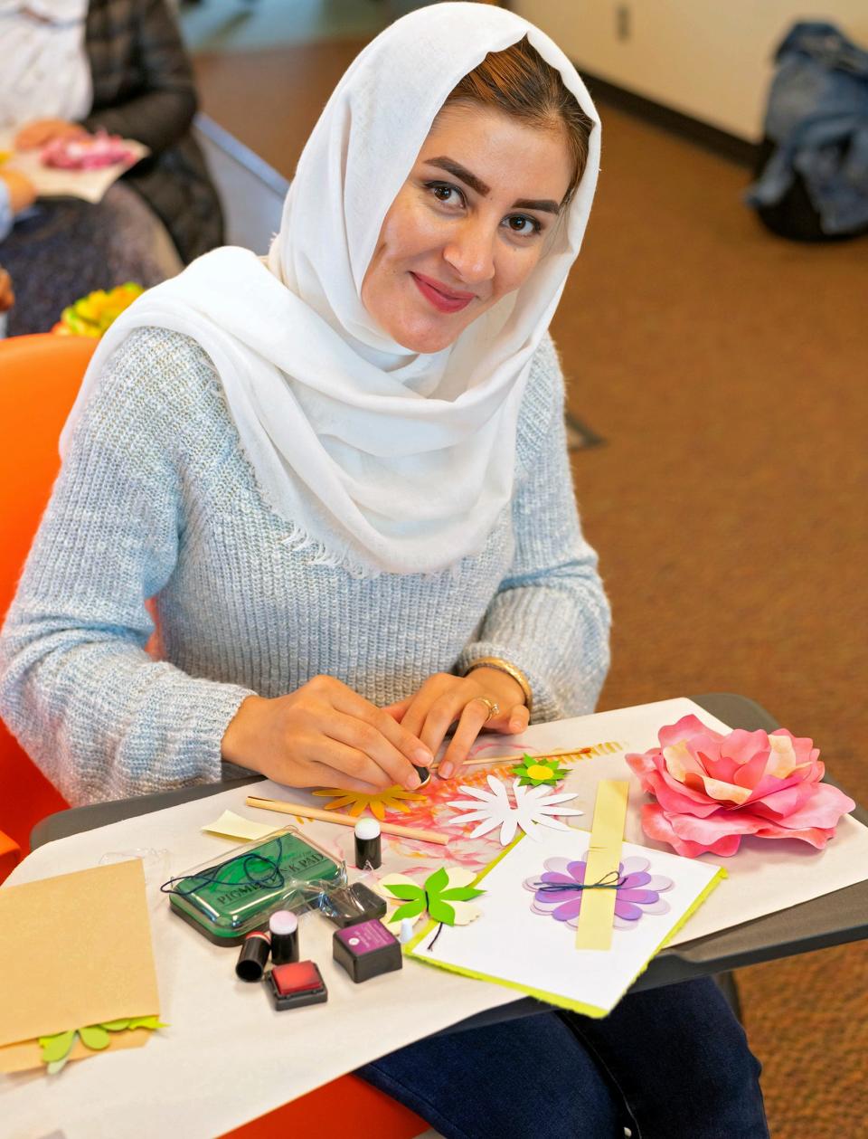 Aziza Kermani works on a Mother's Day craft project during an arts and crafts session for Afghan refugees at Oklahoma State University in Stillwater.