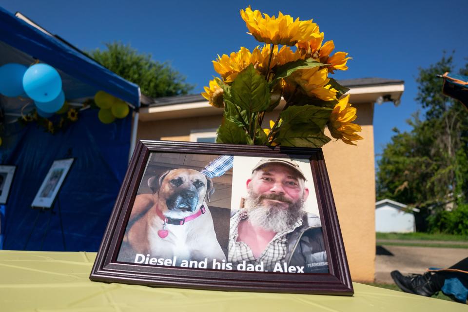 A portrait of Tuscaloosa native Alex Drueke and his dog Diesel rests on a table outside of Forest Lake United Methodist Church during the Tuscaloosa Metro Animal Shelter’s Big Dogs, Big Hearts adoption event in honor of Alabamian-Ukrainian POWS Andy Huynh and Alex Drueke outside of Forest Lake United Methodist Church. Both Drueke and Huynh are big dog lovers. Saturday August 13, 2022. [Photo/Will McLelland] 