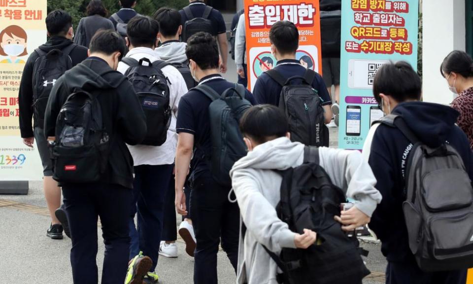 High school students arrive at a high school in Seoul