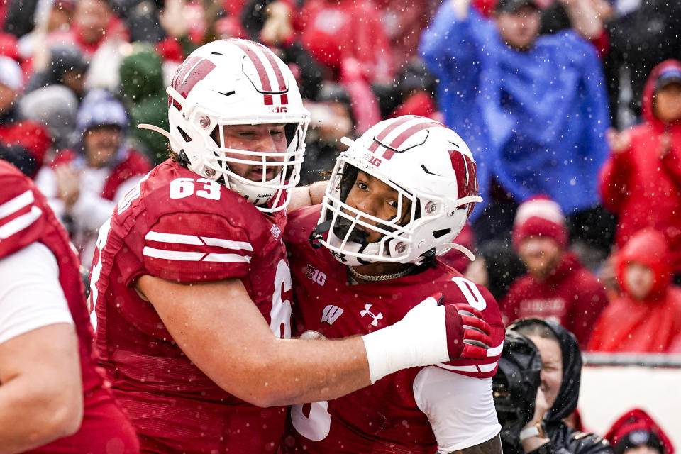 Wisconsin offensive lineman Tanor Bortolini (63) celebrates a touchdown by running back Braelon Allen (0) during the first half of an NCAA college football game against Maryland, Saturday, Nov. 5, 2022, in Madison, Wis. (AP Photo/Andy Manis),