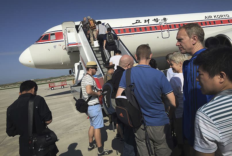 Passengers board an Air Koryo plane at the Pyongyang International Airport in Pyongyang, North Korea, on June 27, 2015.