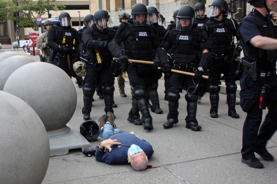 Martin Gugino, a 75-year-old protester, lays on the ground after he was shoved by two Buffalo police officers during a protest Thursday. (Jamie Quinn via Reuters)