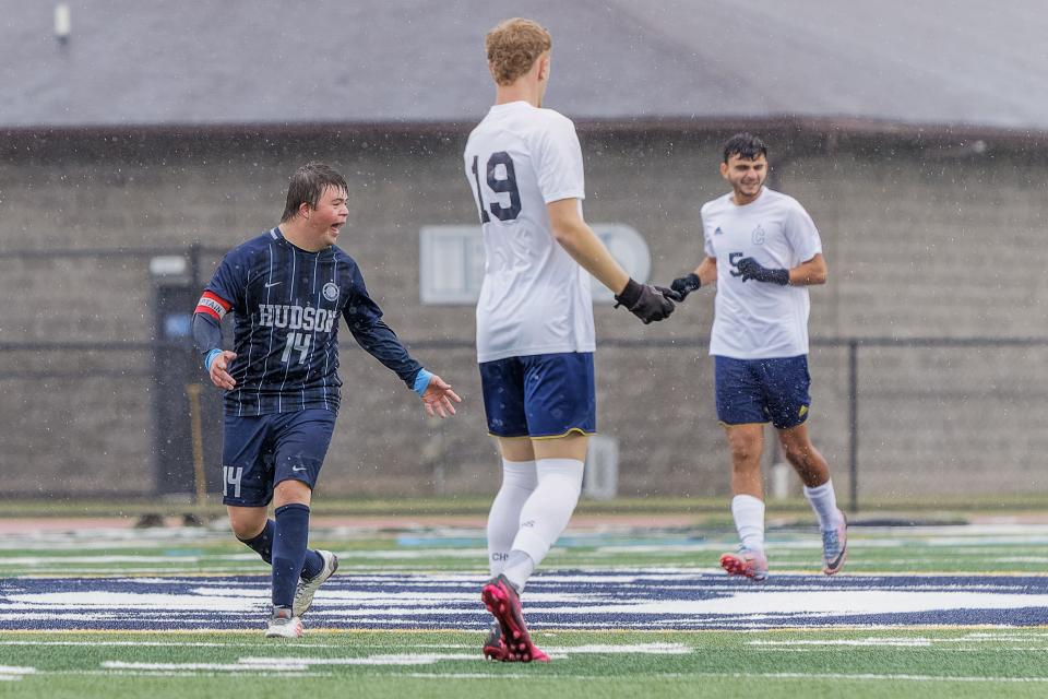 Hudson senior Nicholas Savelli (14) and Copley seniors Asher Hart (19) and Mohammed Alghefari (5) compete in a boys soccer match Saturday in Hudson.