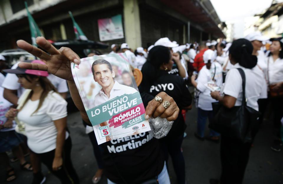 A supporter of Romulo Roux, presidential candidate of the Democratic Change Party, holds up a party leaflet during his closing campaign rally in Panama City, Thursday, May 2, 2019. Roux has tried to capitalize on economic unease. (AP Photo/Arnulfo Franco)