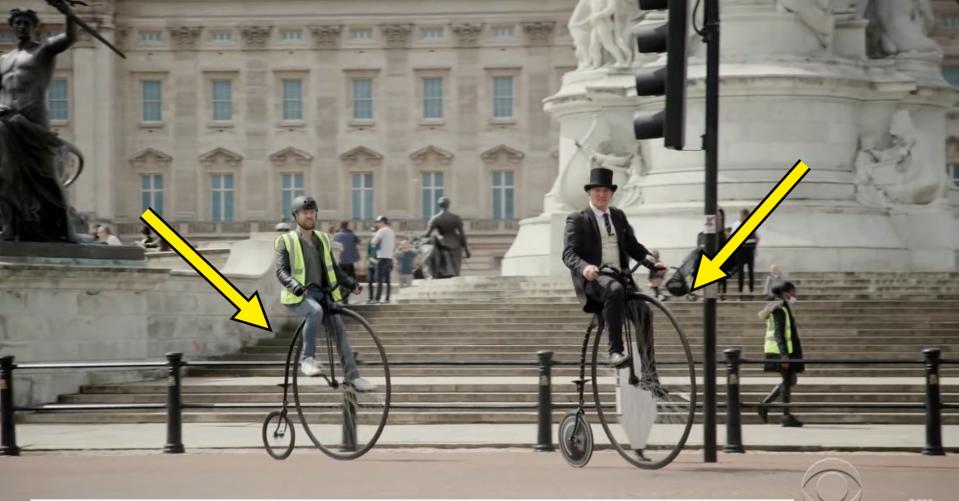 Two men are riding penny-farth bicycles