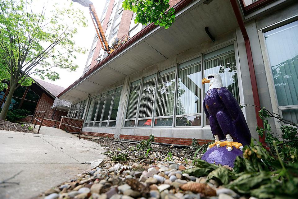 A worker is seen working on the exterior of Clayton Hall Wednesday, May 25, 2022. Clayton Hall is being renovated by Ashland University this summer. TOM E. PUSKAR/TIMES-GAZETTE.COM