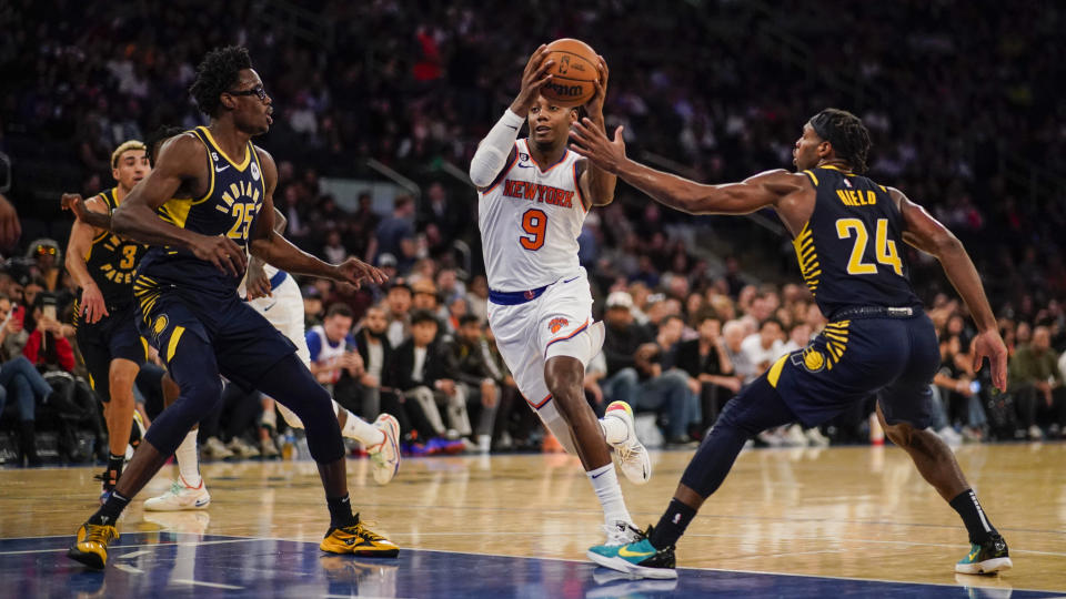 New York Knicks guard RJ Barrett (9) drives the ball against Indiana Pacers forward Jalen Smith (25) and guard Buddy Hield (24) during the second half of a preseason NBA basketball game Friday, Oct. 7, 2022, in New York. (AP Photo/Eduardo Munoz Alvarez)