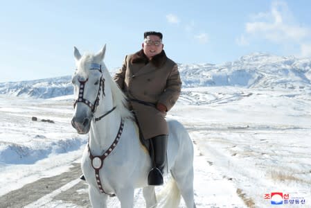 North Korean leader Kim Jong Un rides a horse during snowfall in Mount Paektu