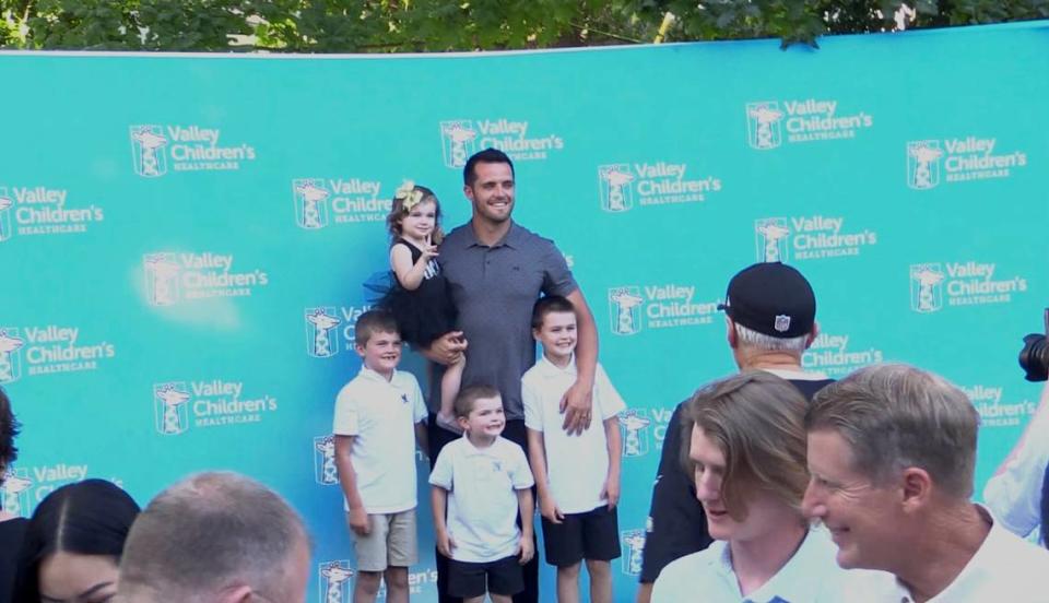 New Orleans Saints quarterback Derek Carr takes a photo with his children in Fresno, California on Saturday, June 24, 2023.