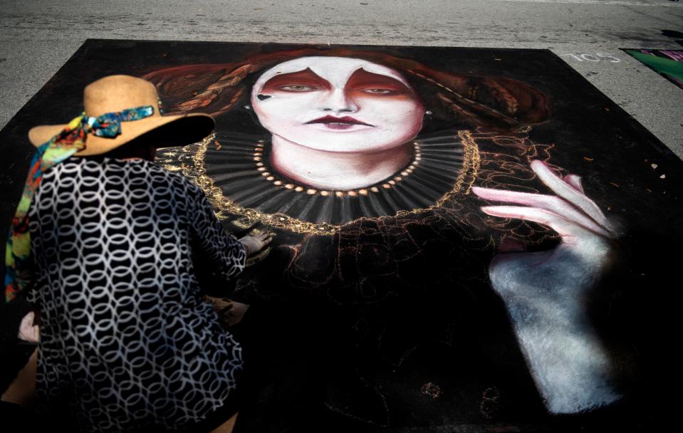 Artist Laura Sheridan paints during the Lake Worth Beach annual Street Painting Festival Sunday February 26, 2023 in Lake Worth Beach. 