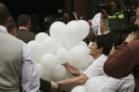 Fans of Oscar Pistorius greet him as he arrives at the high court in Pretoria, South Africa, Monday, April 14, 2014. Pistorius is charged with murder for the shooting death of his girlfriend, Reeva Steenkamp, on Valentines Day in 2013. (AP Photo/Themba Hadebe)