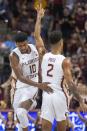Florida State forward Malik Osborne (10) congratulates guard Anthony Polite (2) after a 3-point shot during the first half of the team's NCAA college basketball game against Virginia in Tallahassee, Fla., Wednesday, Jan. 15, 2020. (AP Photo/Mark Wallheiser)