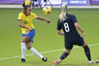 United States midfielder Julie Ertz (8) blocks a shot on goal by Brazil midfielder Marta (10) during the first half of a SheBelieves Cup women's soccer match, Sunday, Feb. 21, 2021, in Orlando, Fla. (AP Photo/Phelan M. Ebenhack)