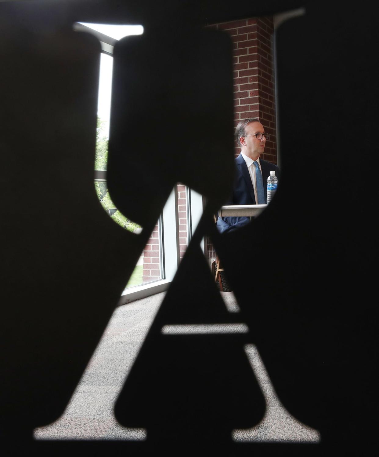 R.J. Nemer, dean of the College of Business and the new president of the University of Akron, is pictured through a UA cutout in the back of a chair on Wednesday.