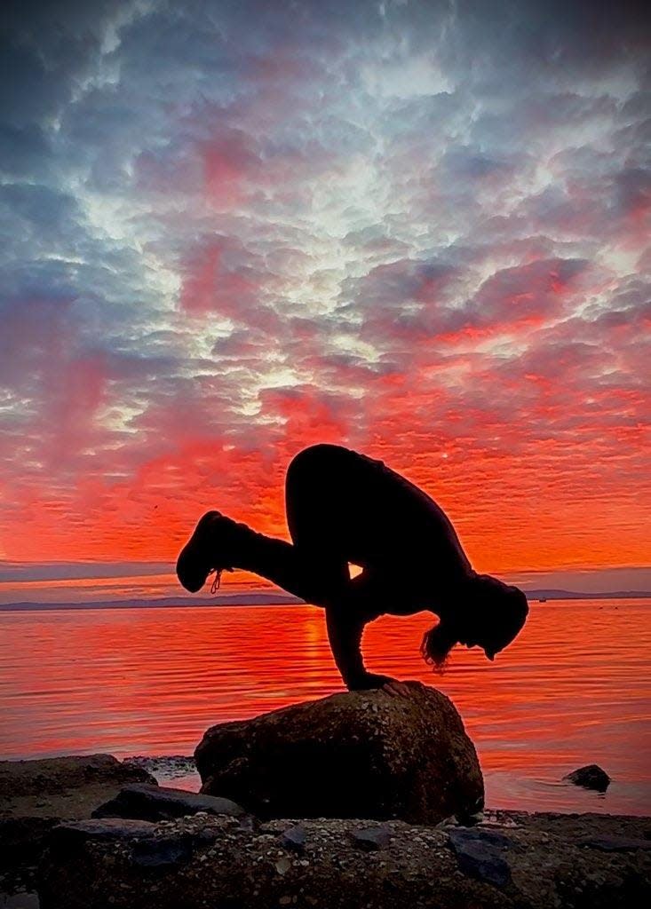 Jason Henry does the Black Crow, one of his favorite yoga positions.