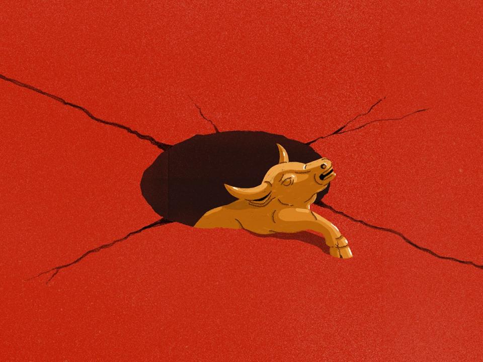 Wall Street bull falling into a large crater on a red background.