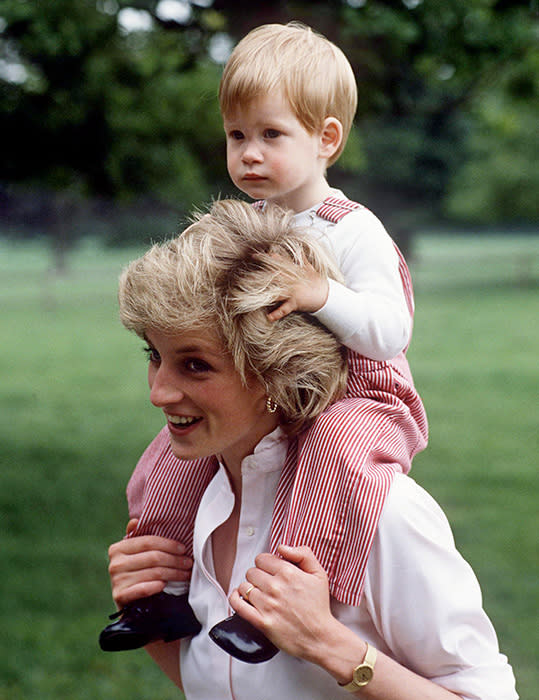 Prince Harry, as a child, over the shoulders of Princess Diana