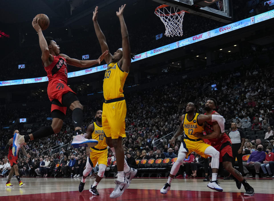 Toronto Raptors forward Scottie Barnes (4) drives to the rim against Indiana Pacers center Myles Turner (33) during the first half of an NBA basketball game, Wednesday, Oct. 27, 2021 in Toronto. (Nathan Denette/The Canadian Press via AP)