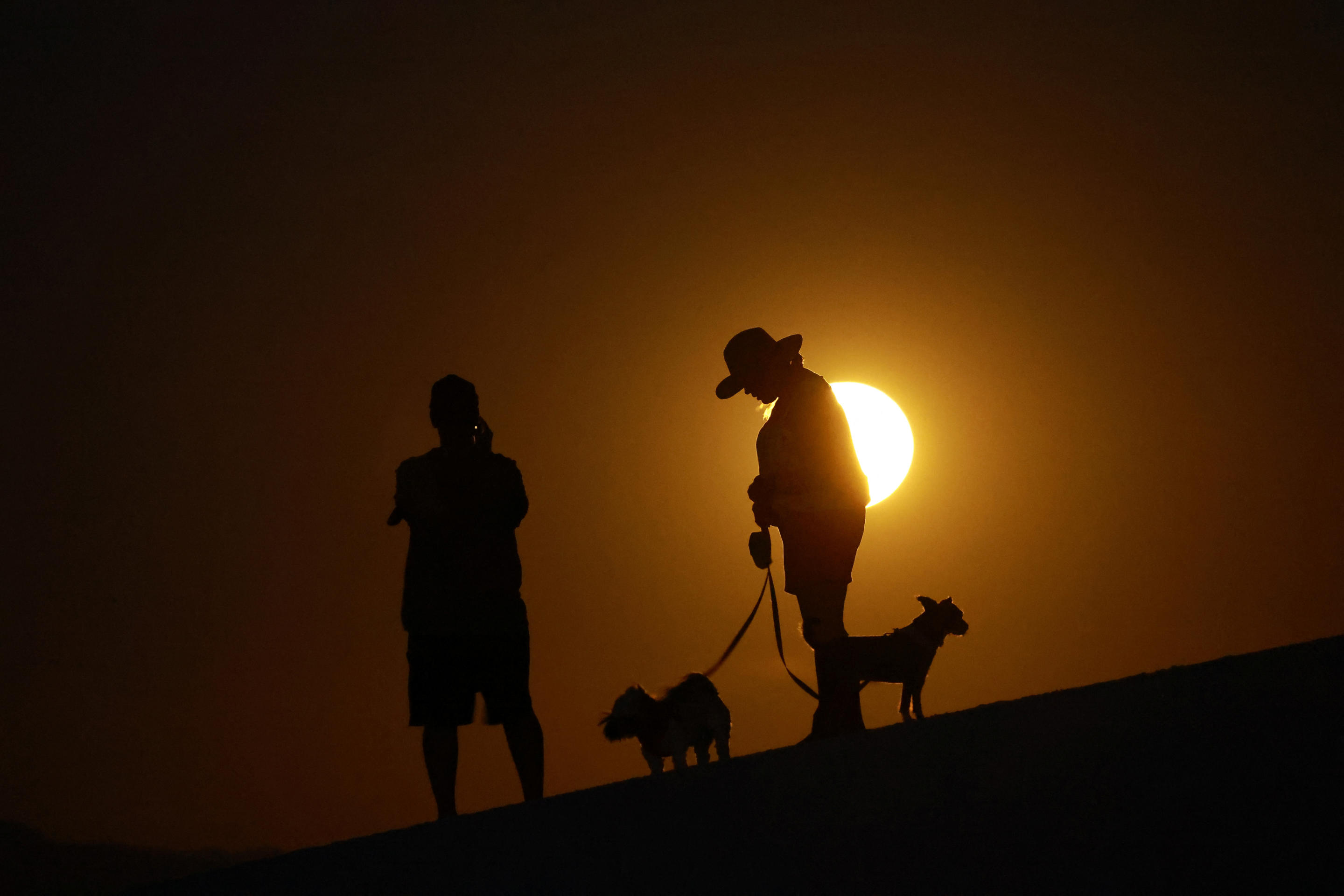 People gather to watch the supermoon, also known as the blue moon and 