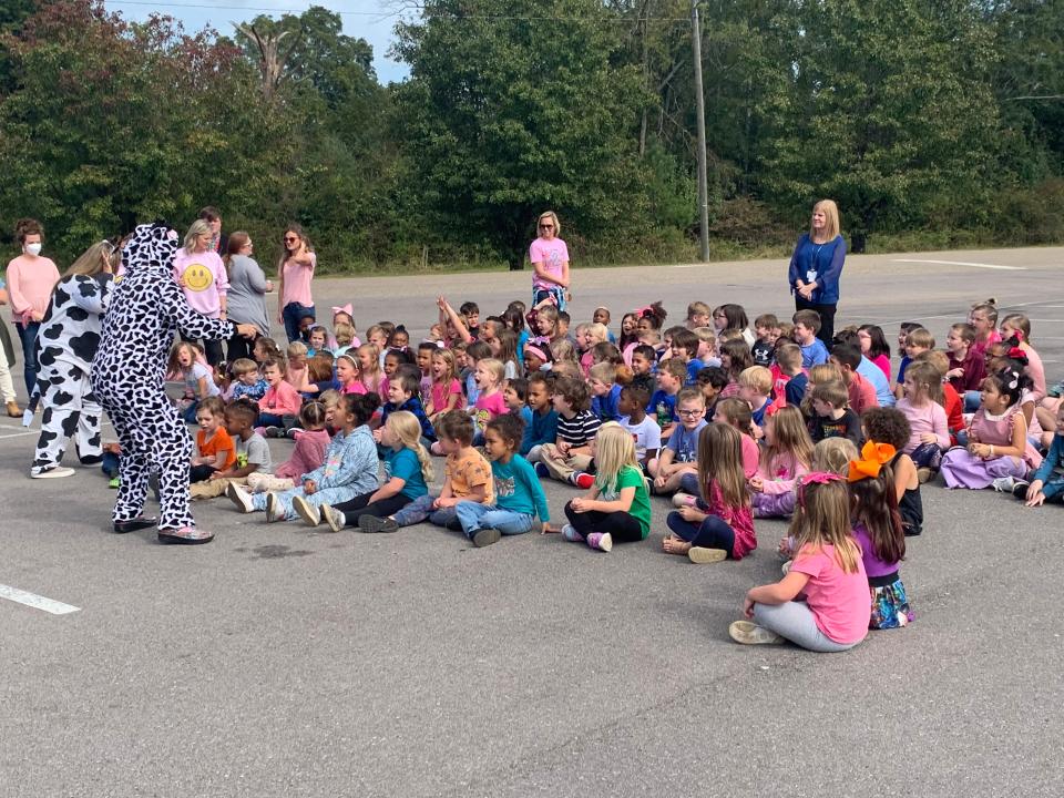 Students of John S. Jones Elementary School dressed up in pink or blue to show support for their chosen team at the gender reveal for the baby calf adopted by the school.