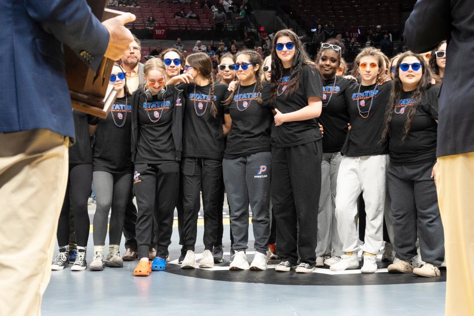 Mar 10, 2024; Columbus, Ohio, USA; Olentangy Orange girls wrestlers gather to accept their OHSAA award following the Ohio State Wrestling Final round at Value City Arena.