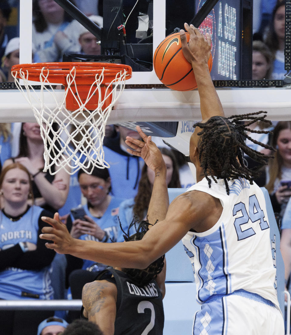 North Carolina's Jae'Lyn Withers (24) blocks the shot of Virginia Tech's MJ Collins (2) during the first half of an NCAA college basketball game in Chapel Hill, N.C., Saturday, Feb. 17, 2024. (AP Photo/Ben McKeown)