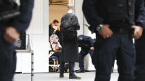 The 96-year-old defendant Irmgard F. sits in an ambulance chair as she arrives in a courtroom in Itzehoe, Germany, Tuesday, Oct. 19, 2021. The woman is charged of more than 11,000 counts of accessory to murder. Prosecutors argue that the 96-year-old woman was part of the apparatus that helped the Nazi camp function more than 75 years ago. (Christian Charisius/DPA via AP, Pool)