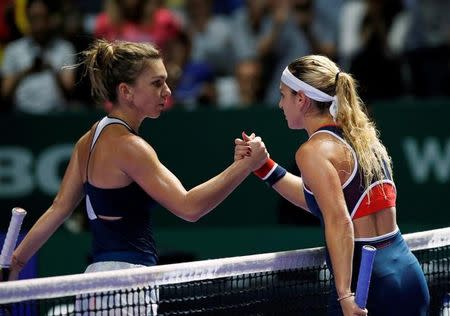 Tennis - Singapore WTA Finals Round Robin Singles - Singapore Indoor Stadium, Singapore - 27/10/16 - Simona Halep of Romania (L) congratulates Dominika Cibulkova of Slovakia. REUTERS/Edgar Su