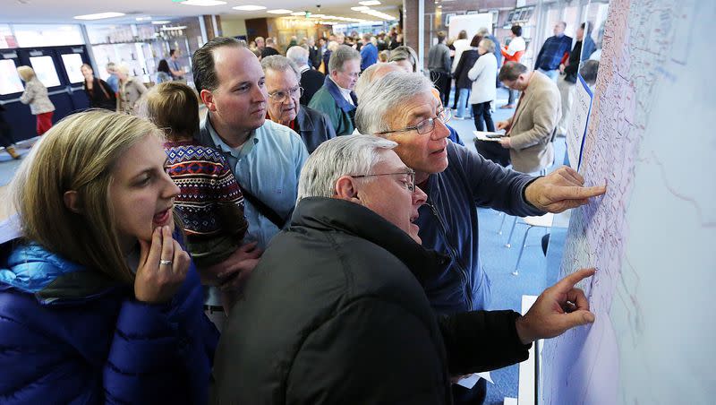 Mickelle Bailey, left, James Bay, front center, and David Chavis, back right, search to find their precinct before the Utah Republican presidential preference caucus at Brighton High School in Cottonwood Heights on March 22, 2016. Utahns again held political caucuses this week.