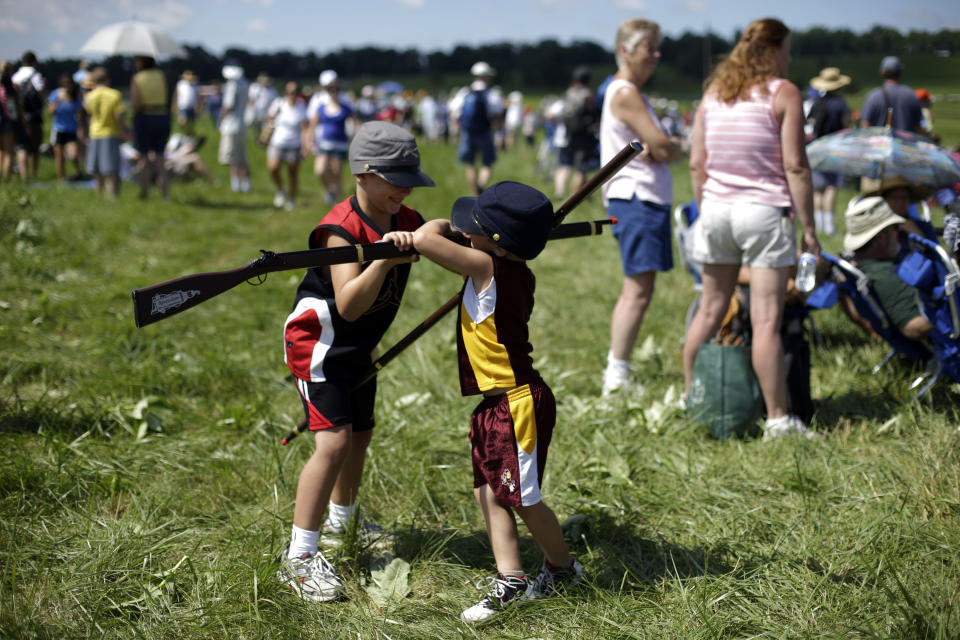 In this Saturday, June 29, 2013 photo, Luke Johnson, 6, left, and his brother Andrew Johnson, 5, of Carterville, Ill., play after a re-enactment during ongoing activities commemorating the 150th anniversary of the Battle of Gettysburg, at Bushey Farm in Gettysburg, Pa. Union forces turned away a Confederate advance in the pivotal battle of the Civil War fought July 1-3, 1863, which was also the war’s bloodiest conflict with more than 51,000 casualties. (AP Photo/Matt Rourke)