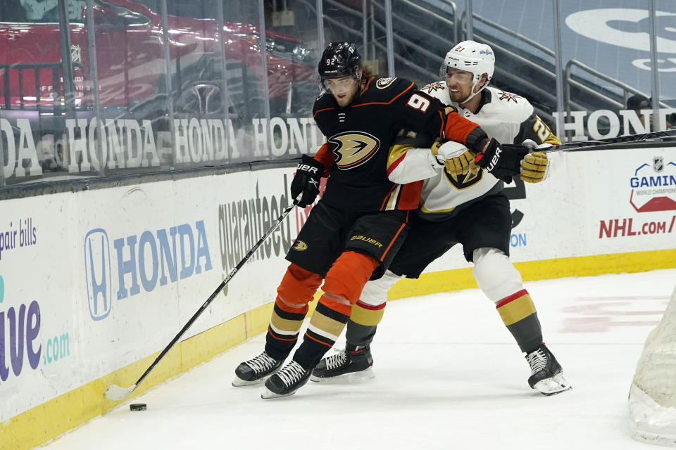 Anaheim Ducks right wing Alexander Volkov, left, is defended by Vegas Golden Knights defenseman Shea Theodore during the second period of an NHL hockey game Sunday, April 18, 2021, in Anaheim, Calif. (AP Photo/Marcio Jose Sanchez)