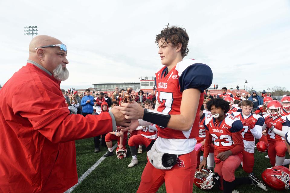 Bridgewater-Raynham head football coach Lou Pacheco gives the MVP to Declan Byrne following the Thanksgiving Day game against Brockton on Thursday, Nov. 25, 2021.