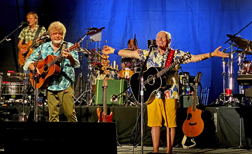 FILE - In this Thursday, Feb. 9, 2023, photo provided by the Florida Keys News Bureau, singer-songwriter Jimmy Buffett, right, along with members of his Coral Reefer Band including Mac McAnally, center, perform during a concert in Key West, Fla. Buffett, who popularized beach bum soft rock with the escapist Caribbean-flavored song “Margaritaville” and turned that celebration of loafing into an empire of restaurants, resorts and frozen concoctions, has died, Friday, Sept. 1, 2023. (Howard Livingston/Florida Keys News Bureau via AP)