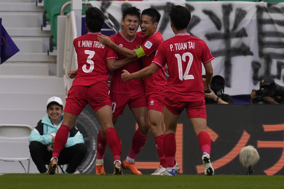 Vietnam's Pham Tuan Hai, second left, celebrates after scoring his side's second goal during the Asian Cup Group D soccer match between Japan and Vietnam at Al Thumama Stadium in Doha, Qatar, Sunday, Jan. 14, 2024. (AP Photo/Thanassis Stavrakis)